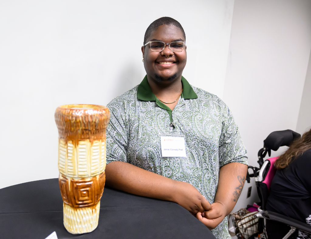 Jamari Cannady Pratt posing with Moonlight sculpture. Photo curtesy of Bennet Scarborough Photography